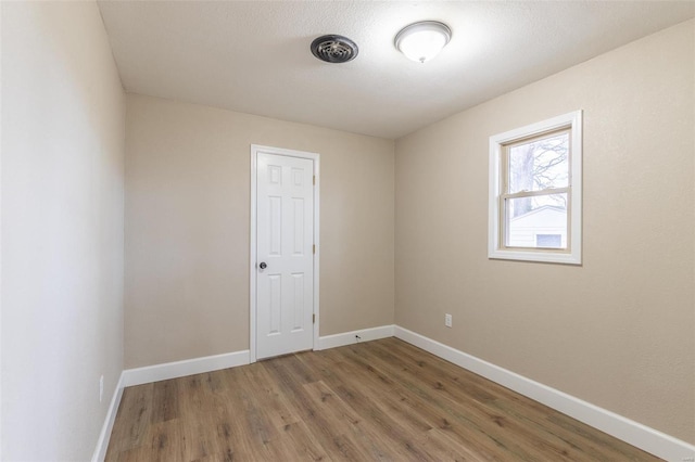 spare room featuring hardwood / wood-style floors