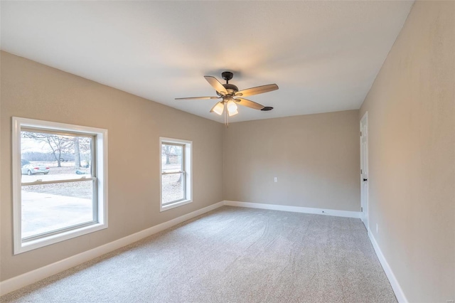 carpeted empty room featuring ceiling fan