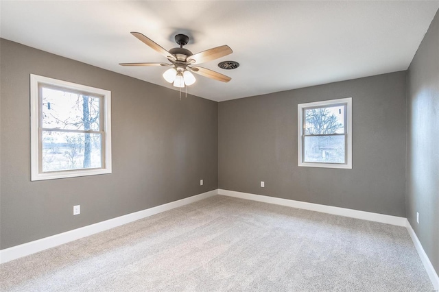 carpeted spare room with ceiling fan