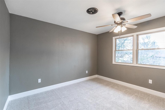 empty room featuring ceiling fan and carpet floors