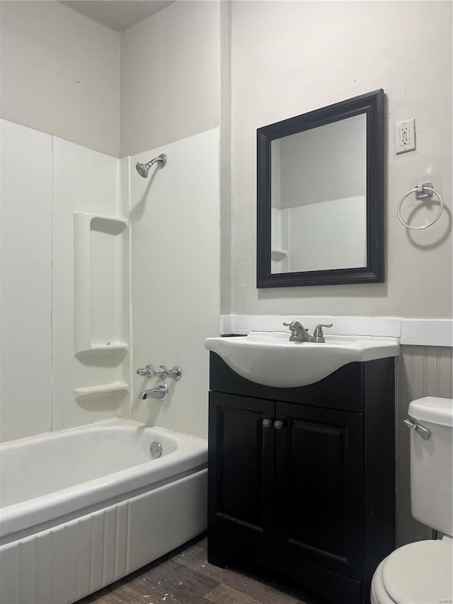 full bathroom with vanity, wood-type flooring, shower / bathtub combination, and toilet