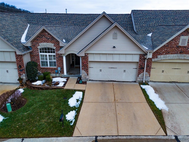 view of front of house with a garage and a front lawn