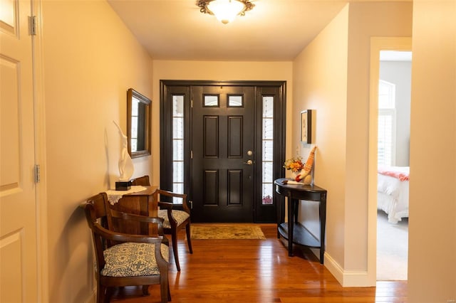 foyer with dark hardwood / wood-style flooring