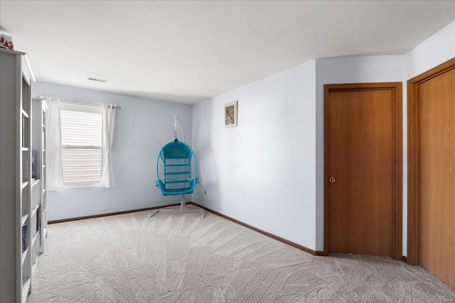 unfurnished bedroom featuring light carpet