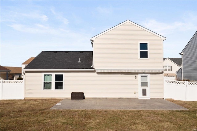 rear view of property with a yard and a patio