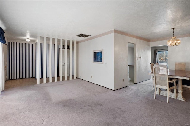 interior space featuring carpet, a textured ceiling, and a chandelier