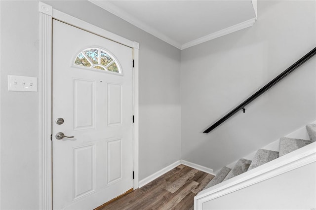 entryway with crown molding and dark wood-type flooring