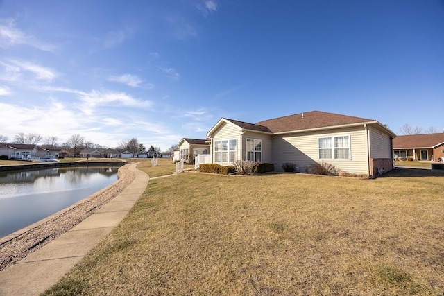 view of property exterior featuring a water view and a yard