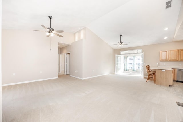 unfurnished living room featuring light carpet, high vaulted ceiling, and ceiling fan