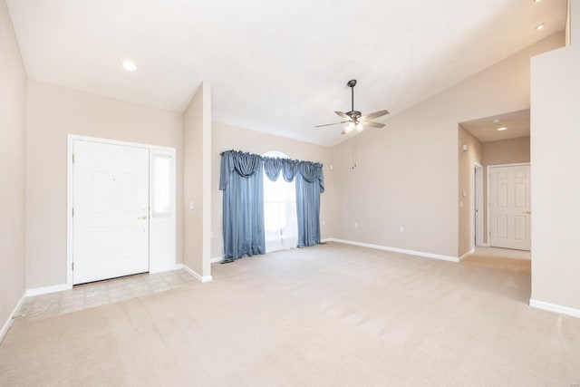 carpeted empty room featuring vaulted ceiling and ceiling fan