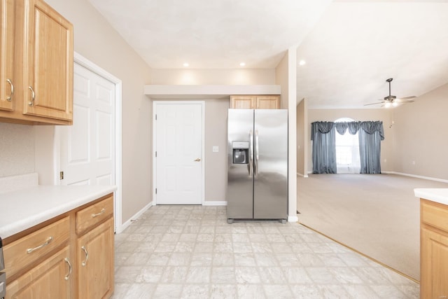 kitchen with light colored carpet, ceiling fan, light brown cabinetry, and stainless steel fridge with ice dispenser