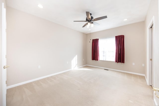 unfurnished bedroom featuring light colored carpet and ceiling fan