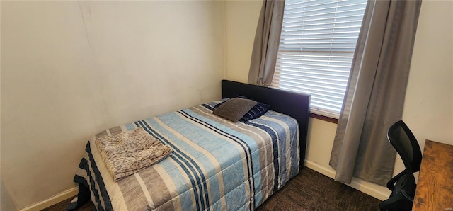 bedroom featuring dark carpet