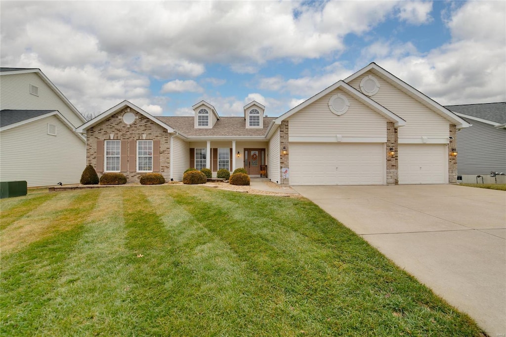 view of front of house with a garage, covered porch, and a front lawn