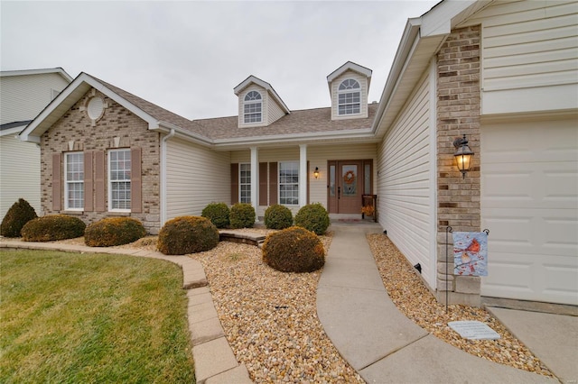 view of front of property featuring a garage and a front lawn