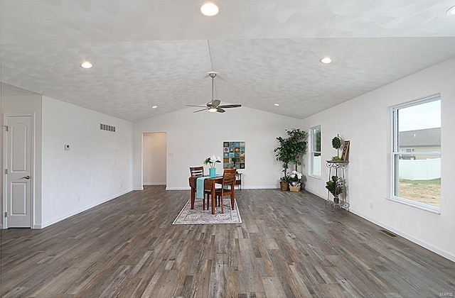 unfurnished dining area with lofted ceiling, dark hardwood / wood-style floors, and ceiling fan