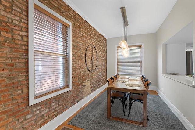 dining space with brick wall