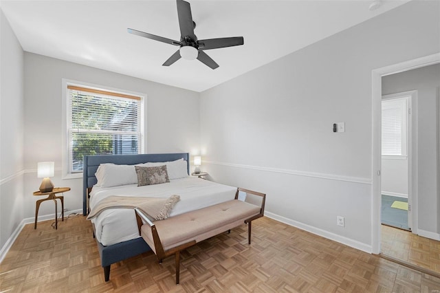 bedroom with ceiling fan and light parquet floors