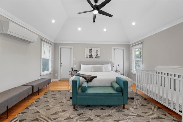 bedroom with crown molding, ceiling fan, light hardwood / wood-style floors, and vaulted ceiling