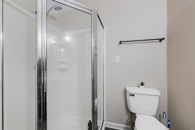 bathroom featuring an enclosed shower and toilet