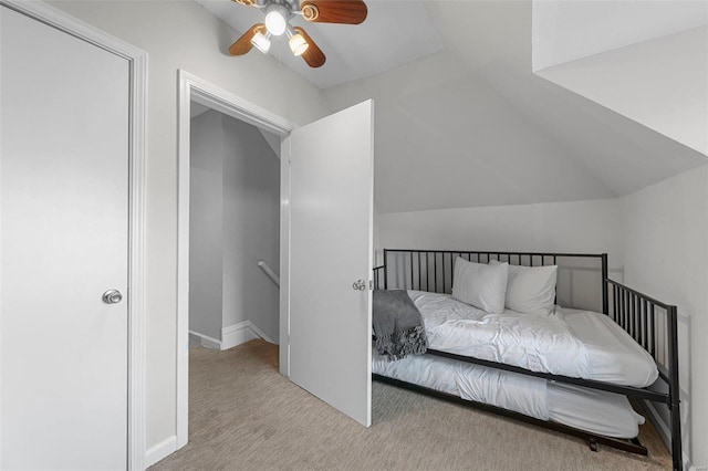 carpeted bedroom featuring ceiling fan and vaulted ceiling