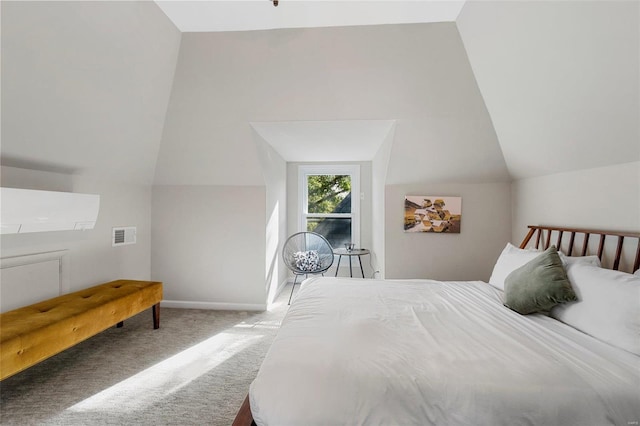 carpeted bedroom with lofted ceiling