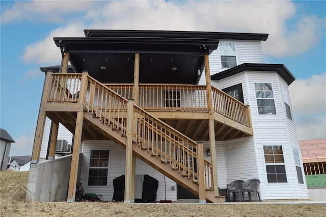 back of property featuring central AC, a wooden deck, and stairs