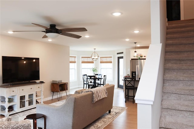 living area featuring recessed lighting, stairway, and wood finished floors