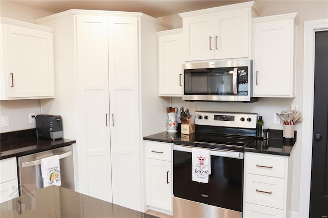 kitchen featuring white cabinetry and appliances with stainless steel finishes