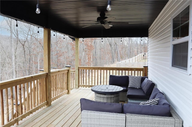 wooden deck featuring a ceiling fan and an outdoor living space