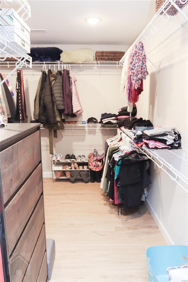 walk in closet featuring light wood finished floors