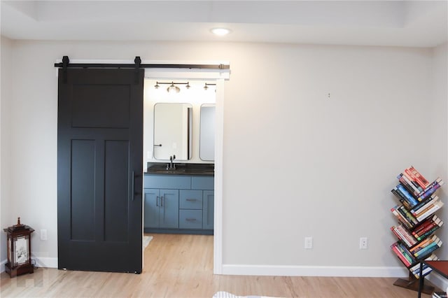 interior space with wood finished floors, vanity, and baseboards