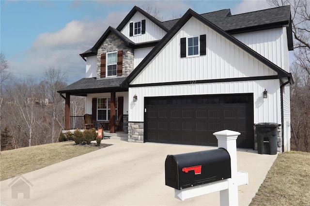 view of front facade with board and batten siding, stone siding, covered porch, and concrete driveway