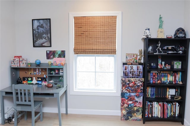 office area with baseboards and wood finished floors