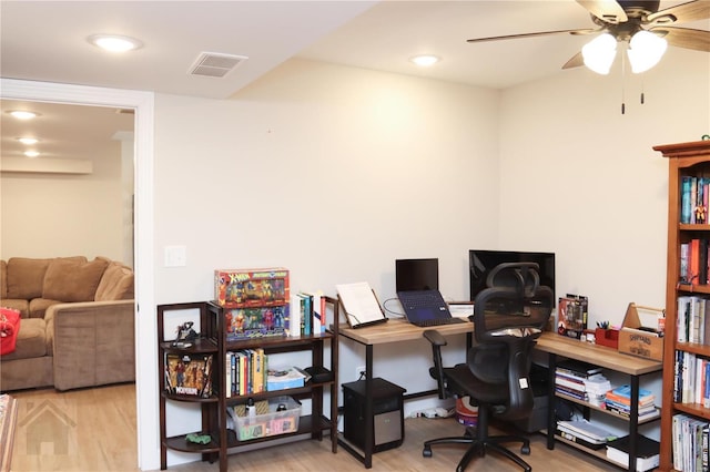 office area with ceiling fan, wood finished floors, and visible vents