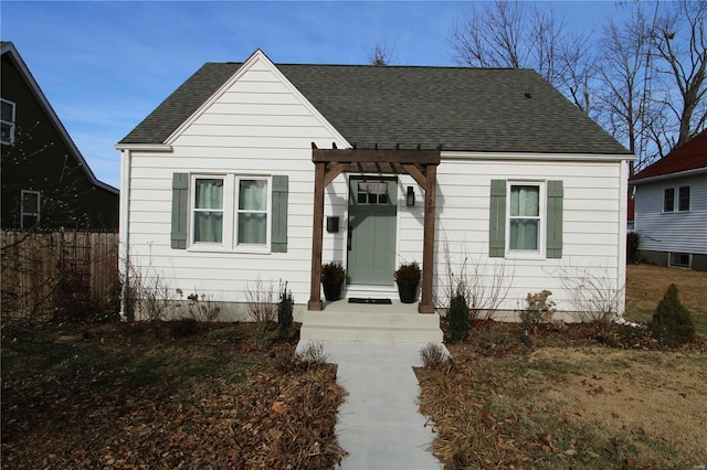 bungalow-style house with a pergola and a front lawn