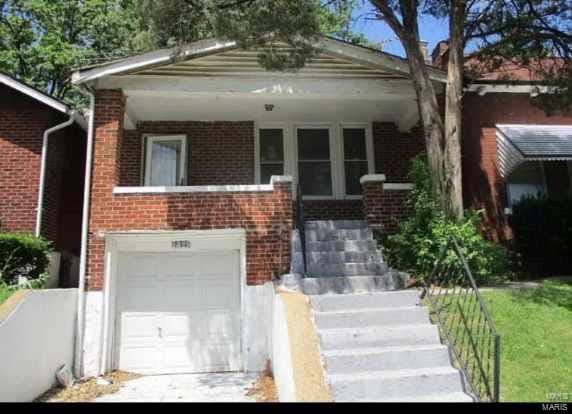 bungalow featuring a porch and a garage