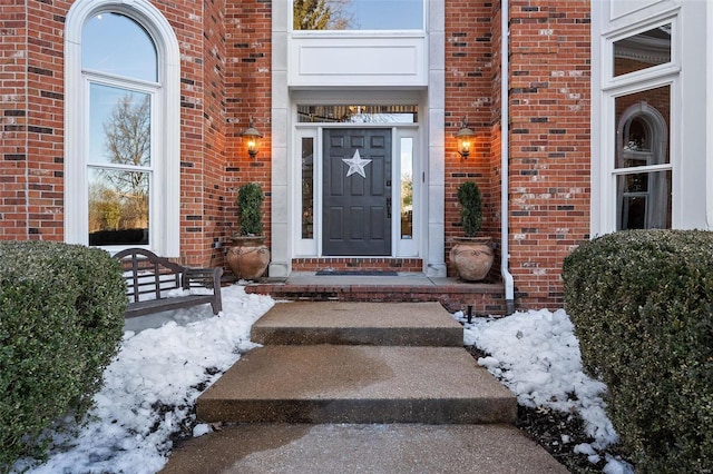 view of snow covered property entrance