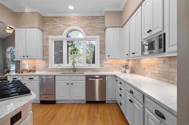 kitchen with white cabinetry, stainless steel appliances, and sink