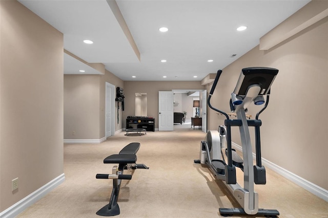 workout room featuring light colored carpet