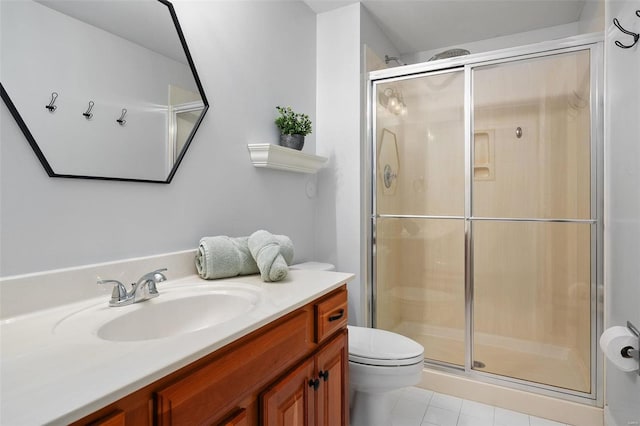 bathroom with vanity, tile patterned floors, toilet, and walk in shower