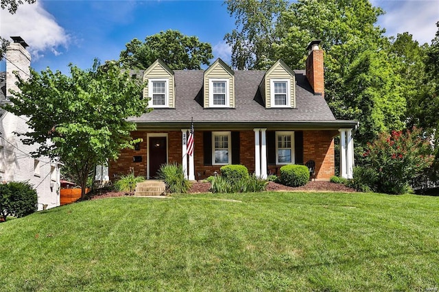 cape cod home with a front lawn