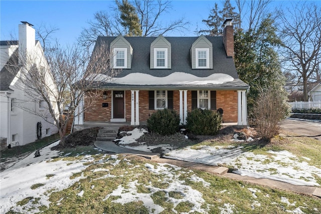 new england style home featuring covered porch