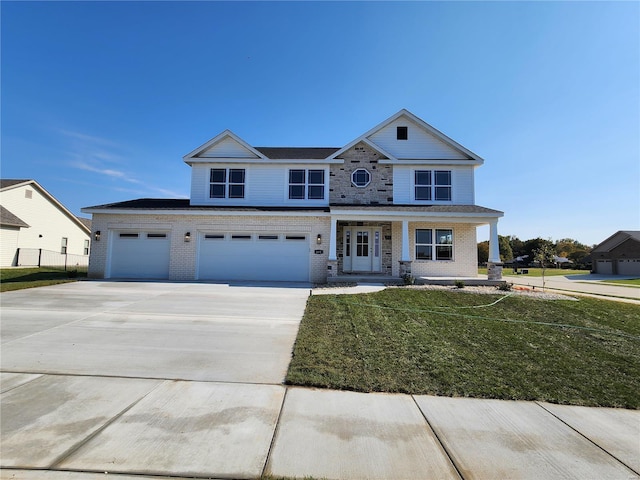 view of front of home with a garage, covered porch, and a front lawn