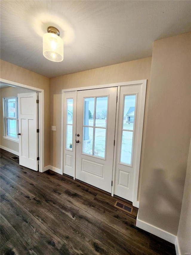 foyer entrance with dark hardwood / wood-style floors