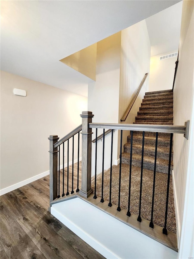 stairway featuring wood-type flooring