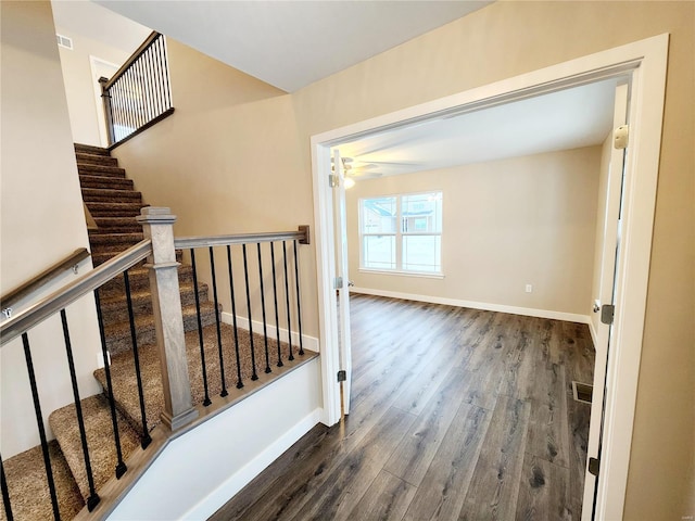 staircase with hardwood / wood-style flooring