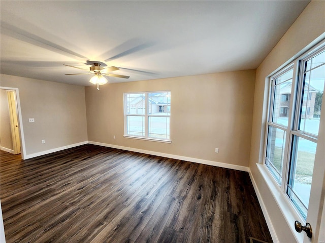 empty room featuring ceiling fan and dark hardwood / wood-style flooring