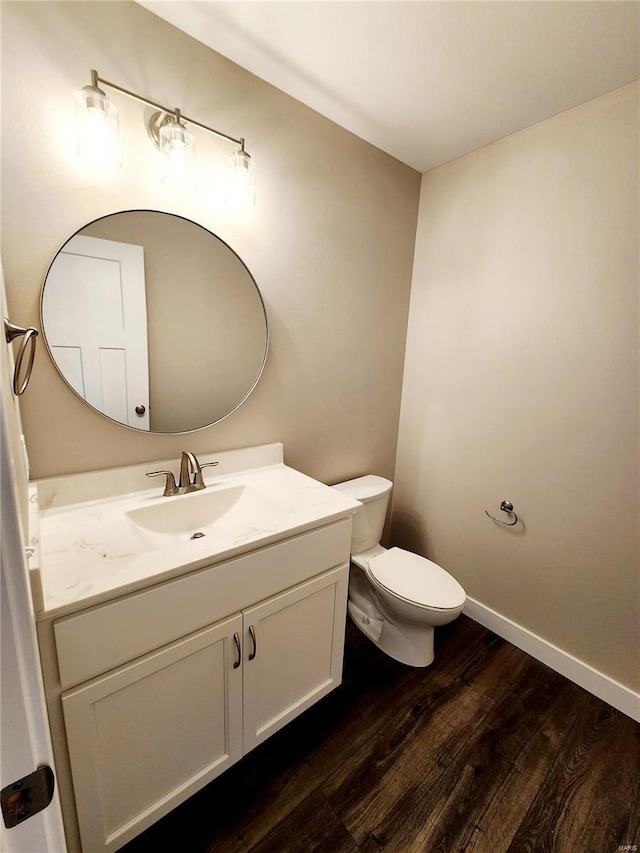 bathroom featuring vanity, toilet, and hardwood / wood-style floors