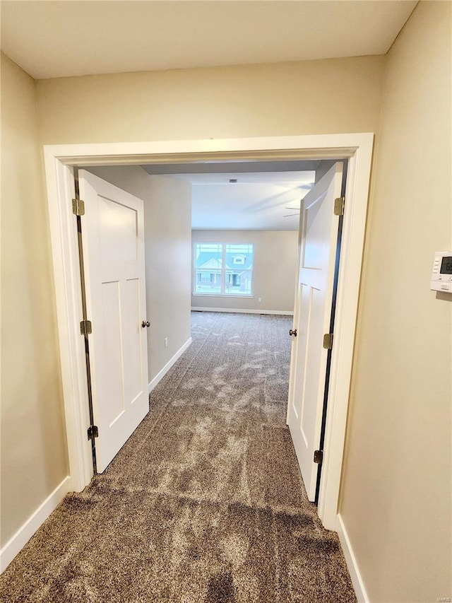 hallway with dark carpet